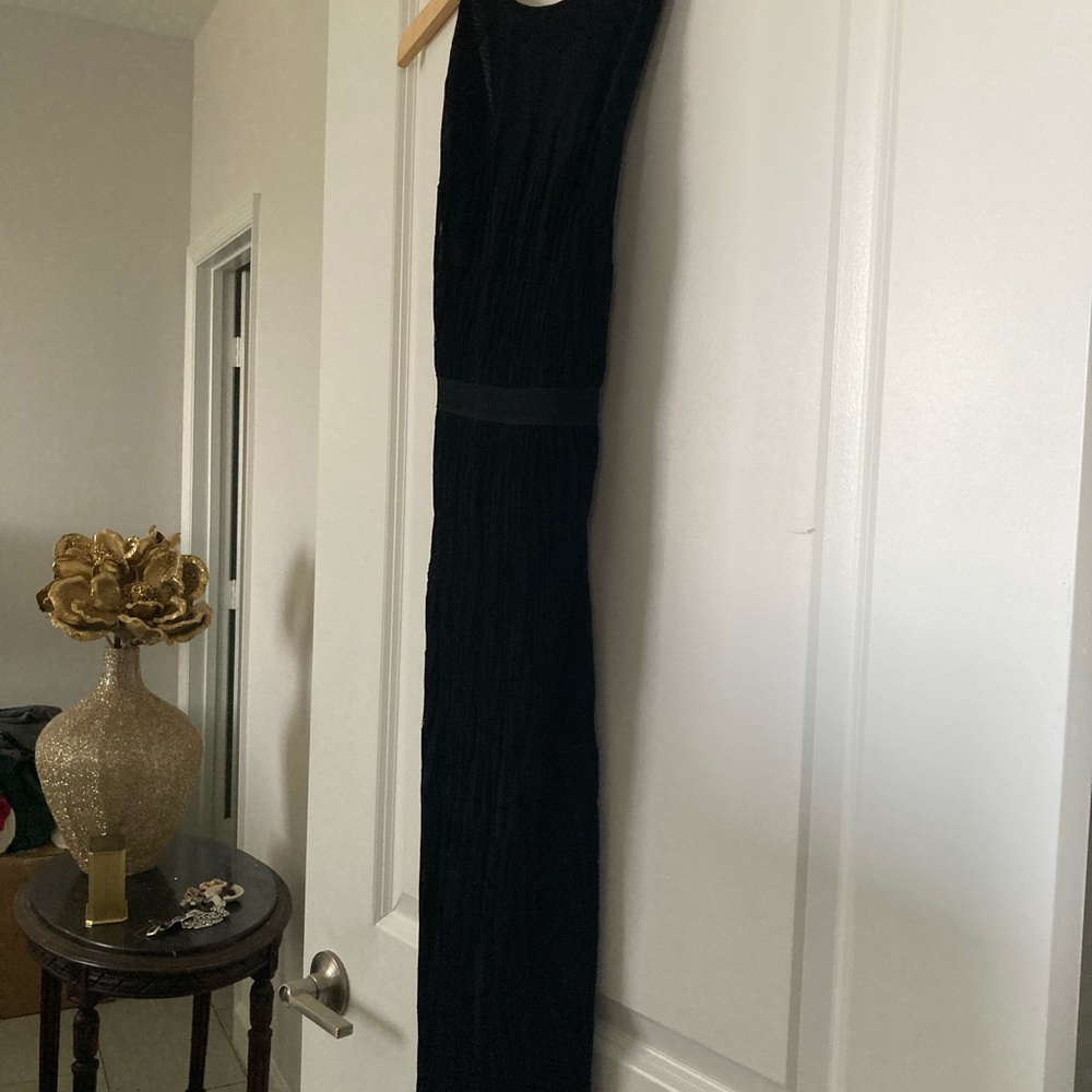 New black Chanel dress, back is open with a delicate C detail.